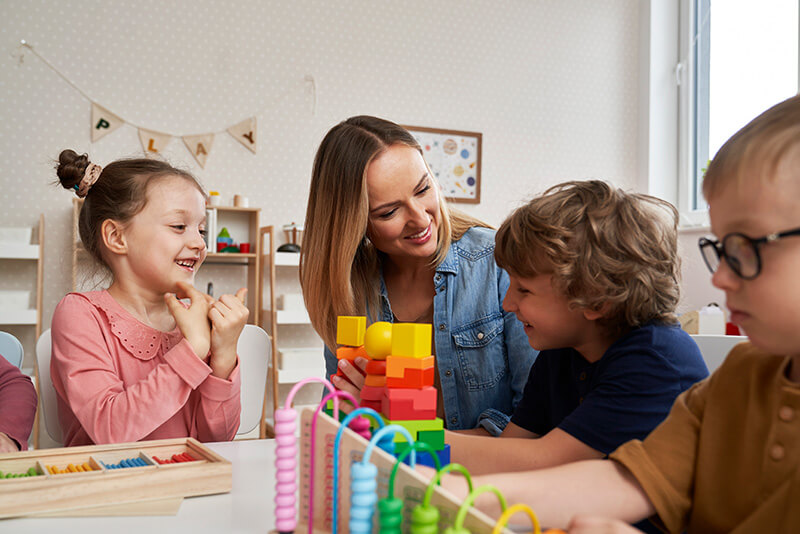 Children working with teacher on sensory games