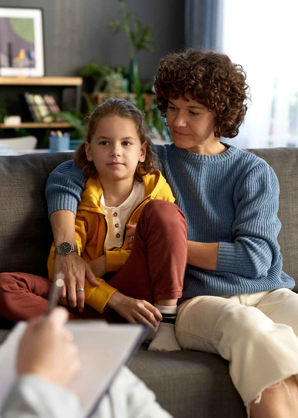 Parent and child meeting with an ABA therapist to discuss individualized autism therapy and family support.